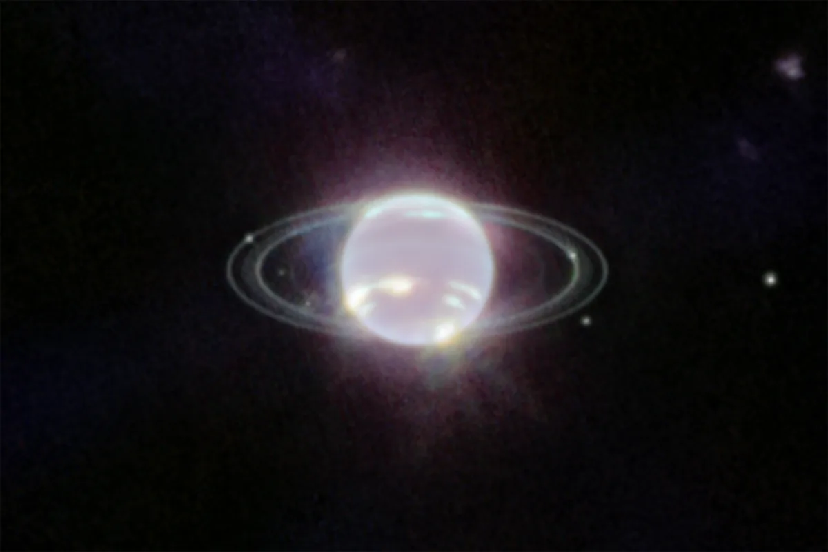 Neptune as a glowing white sphere with bright methane-ice cloud streaks, thin faint rings around it and small white dots that are its moons, on a black background
