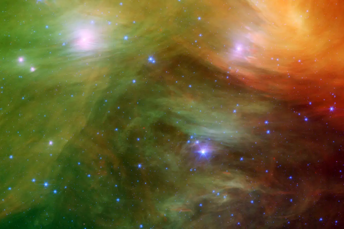 Infrared view of the Pleiades with swirling green, yellow and red clouds of dust around the cluster's stars