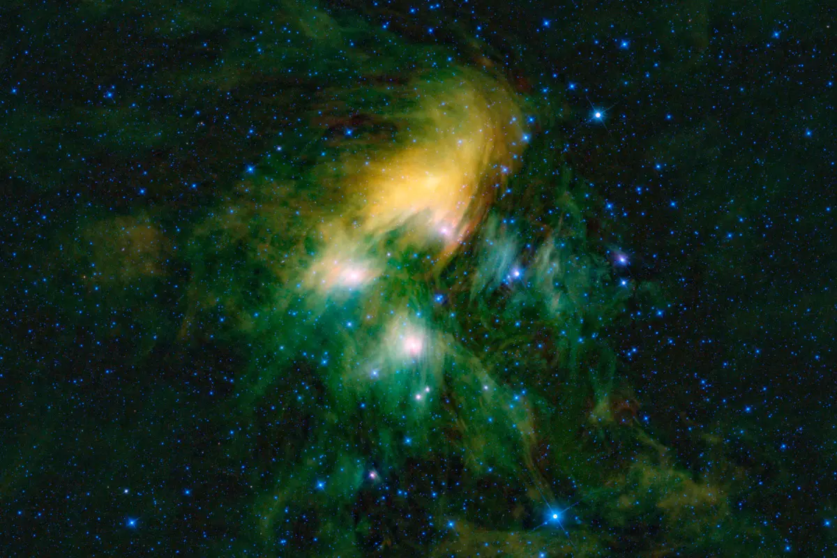 The Pleiades star cluster in an infrared view, with bright stars wrapped in green and yellow clouds of dust